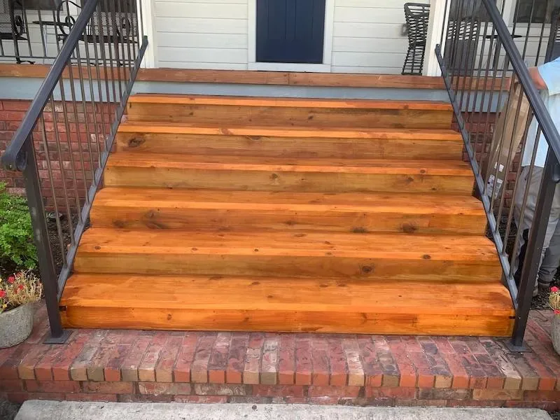 Custom stained wood deck with stairs and metal railings NWA — JHG Contracting