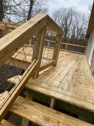 Custom wood deck with cattle fence railing design NWA — JHG Contracting LLC